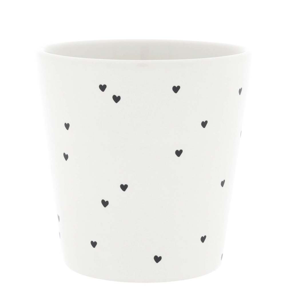 Ein weißer Keramikbecher „Becher Hearts allaround“ von Bastion Collections, verziert mit verstreuten kleinen schwarzen Herzmustern.