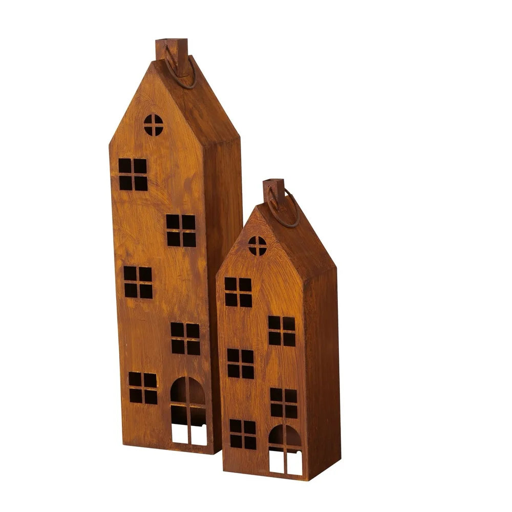 Das Boltze - Laterne Alba Rost Deko Haus Mega 2er-Set zeigt zwei dekorative Holzhäuser mit ausgeschnittenen Fenstern und Türen, spitzen Dächern und kleinen Schleifen an der Spitze, die vor einem weißen Hintergrund stehen.