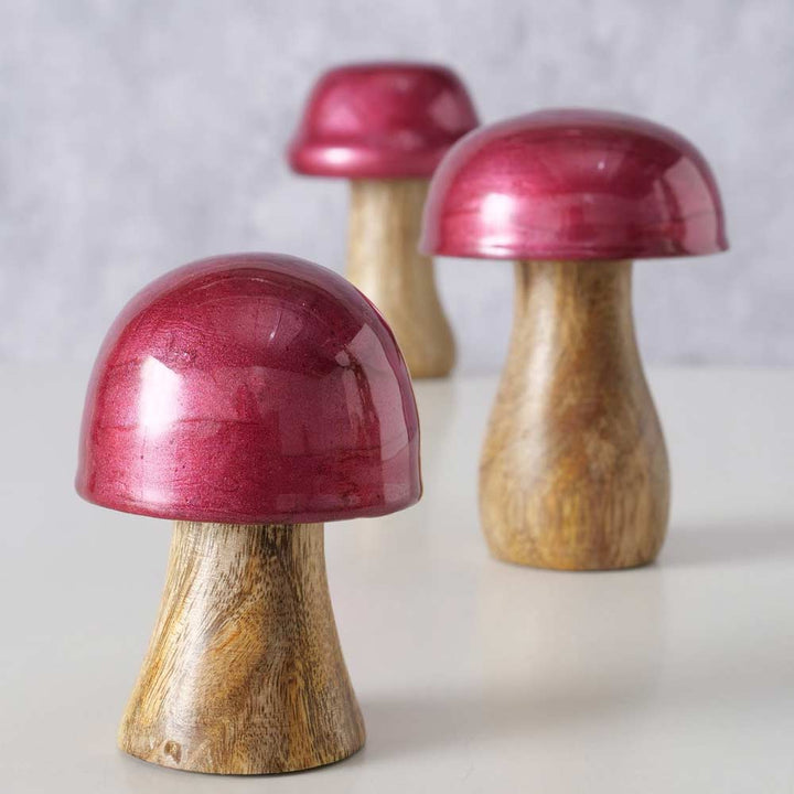 Drei Boltze - Pilz Deko Ella bordeaux Holz-Pilzfiguren aus dem 3er-Set sind auf einem weißen Untergrund platziert.