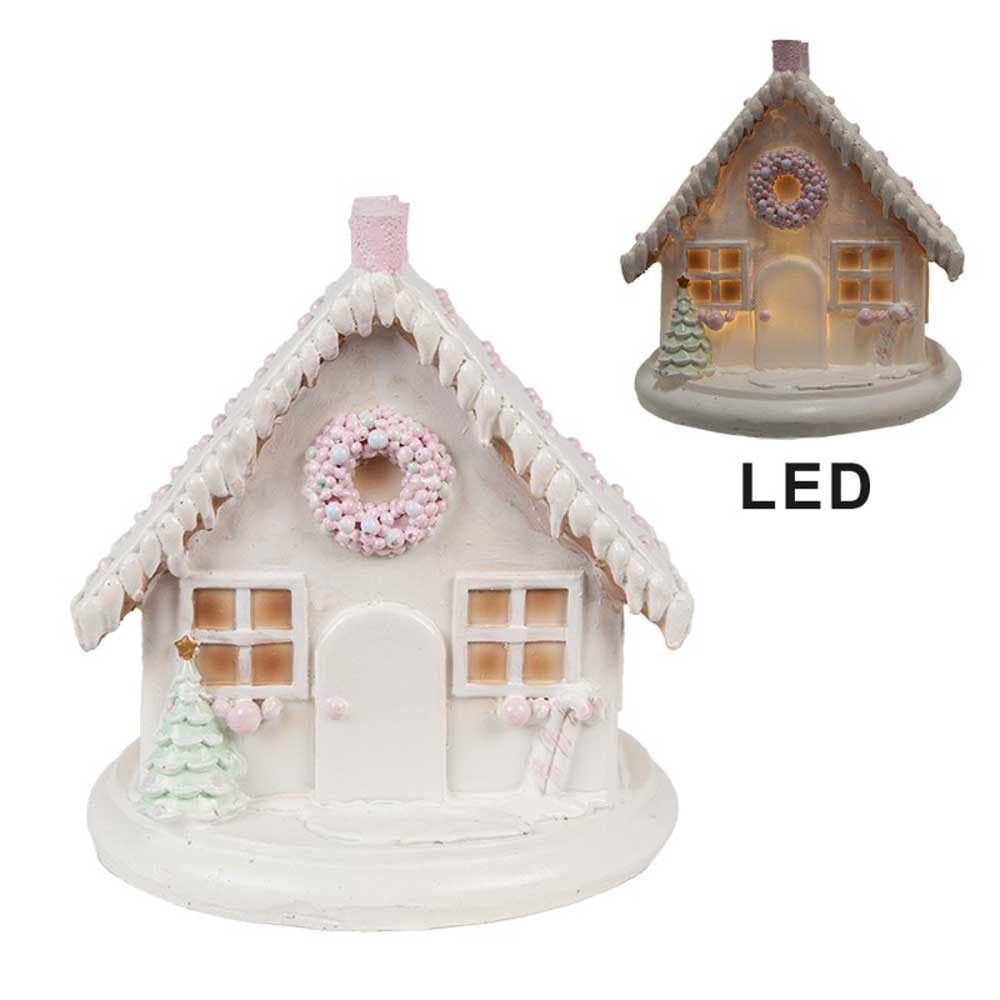 Wir präsentieren das Clayre & Eef - Lebkuchenhaus mit LED 13 cm: ein bezauberndes, kleines weißes Keramikhaus mit LED-Licht, einem schneebedeckten Dach, einem Kranz über der Tür, Bäumen und rosa Verzierungen. Ein kleineres Bild zeigt seine beleuchtete Schönheit.