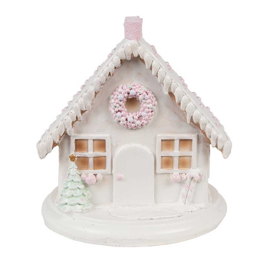 Das Clayre & Eef - Lebkuchenhaus mit LED 13 cm ist ein kleines weißes Keramikhaus mit einem rosa Kranz über der Tür, einem pastellfarbenen Weihnachtsbaum und einer Mini-Zuckerstange an der Seite. Das Dach ist so dekoriert, dass es an Zuckerguss erinnert.