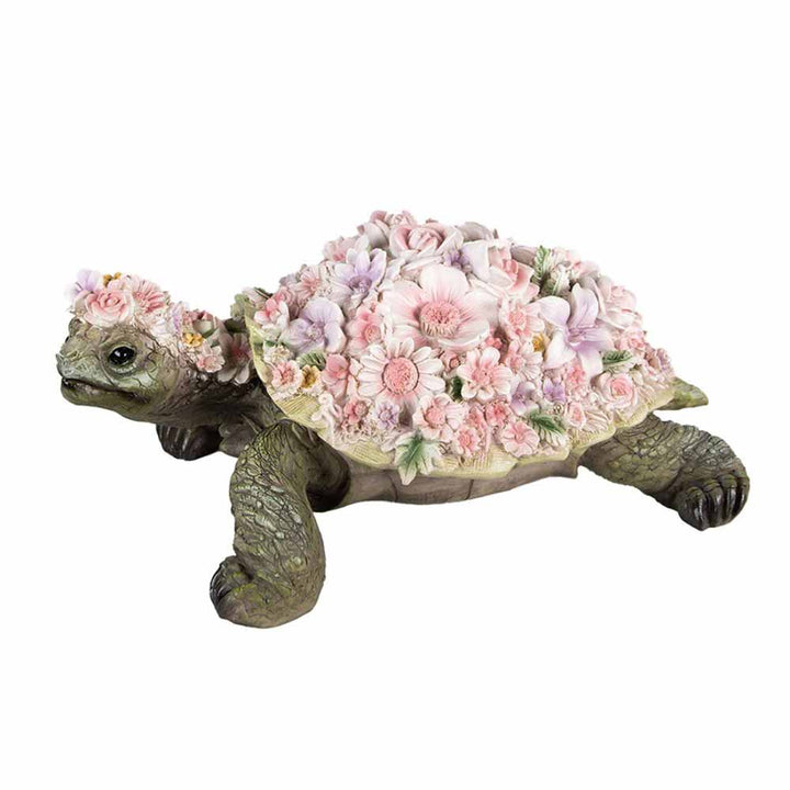 Eine Clayre & Eef-Figur einer Schildkröte mit Blumen auf dem Rücken.