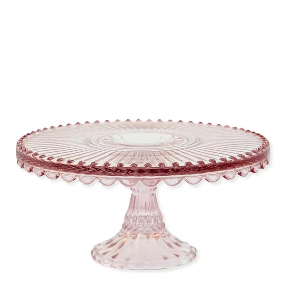 Die GreenGate - Alice Tortenplatte aus Glas ist ein rosa Tortenständer aus Glas mit gewelltem Rand und dekorativem Stiel vor einem schlichten weißen Hintergrund.
