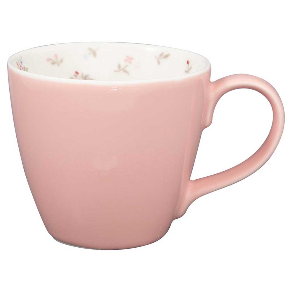 Eine GreenGate - Junia inside Tasse in blassem Rosa, mit einer weißen Innenseite, die mit kleinen, zarten Blumenmustern geschmückt ist.