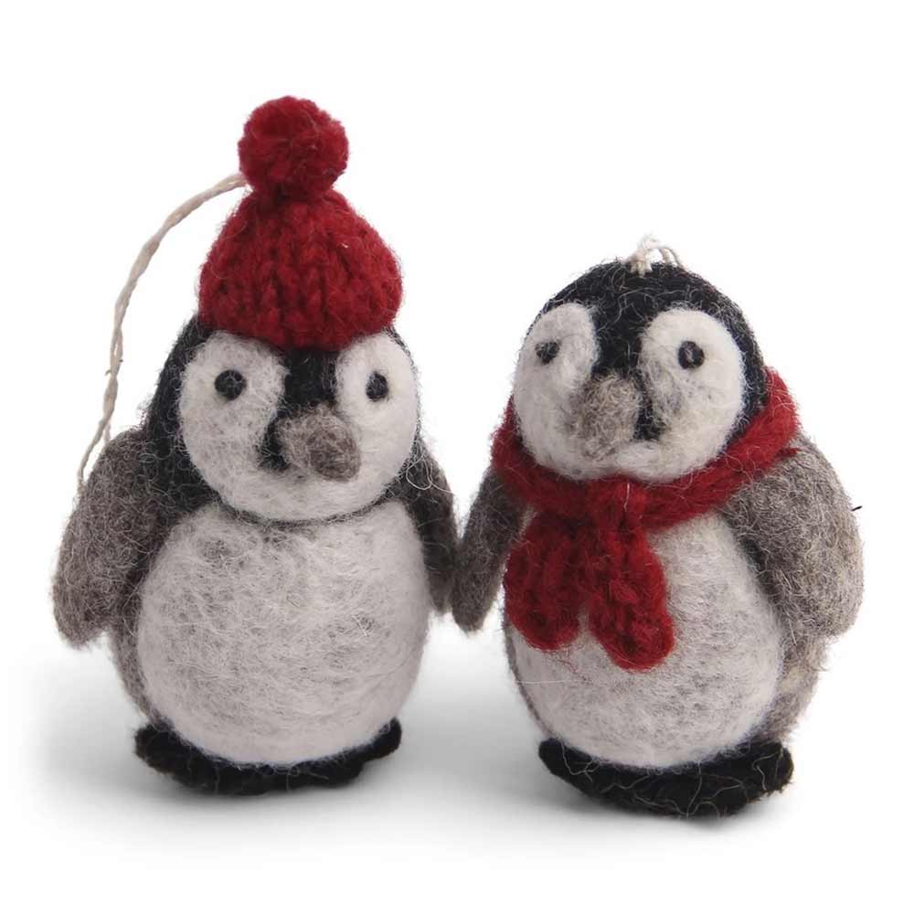 Ein Paar Pinguinfiguren aus Filz aus dem Gry & Sif Anhänger Pinguin Filz 2er-Set, wobei eine Figur eine rote Mütze und die andere einen roten Schal trägt und zusammen vor einem weißen Hintergrund steht.