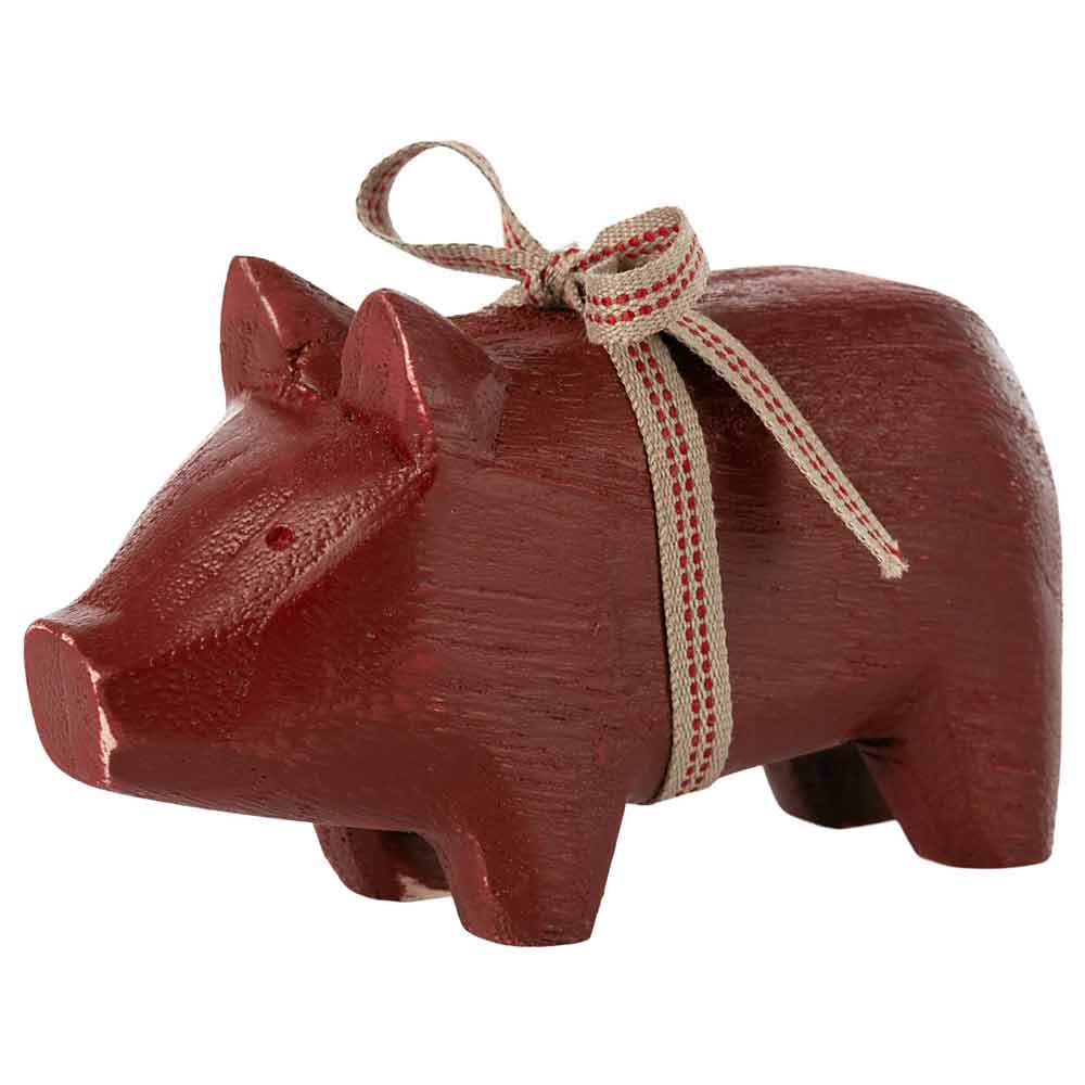 A charming wooden pig with a bow, handcrafted and painted, perfect for holiday decor or as a lucky charm. Maileg - Holzschwein mit Schleife.