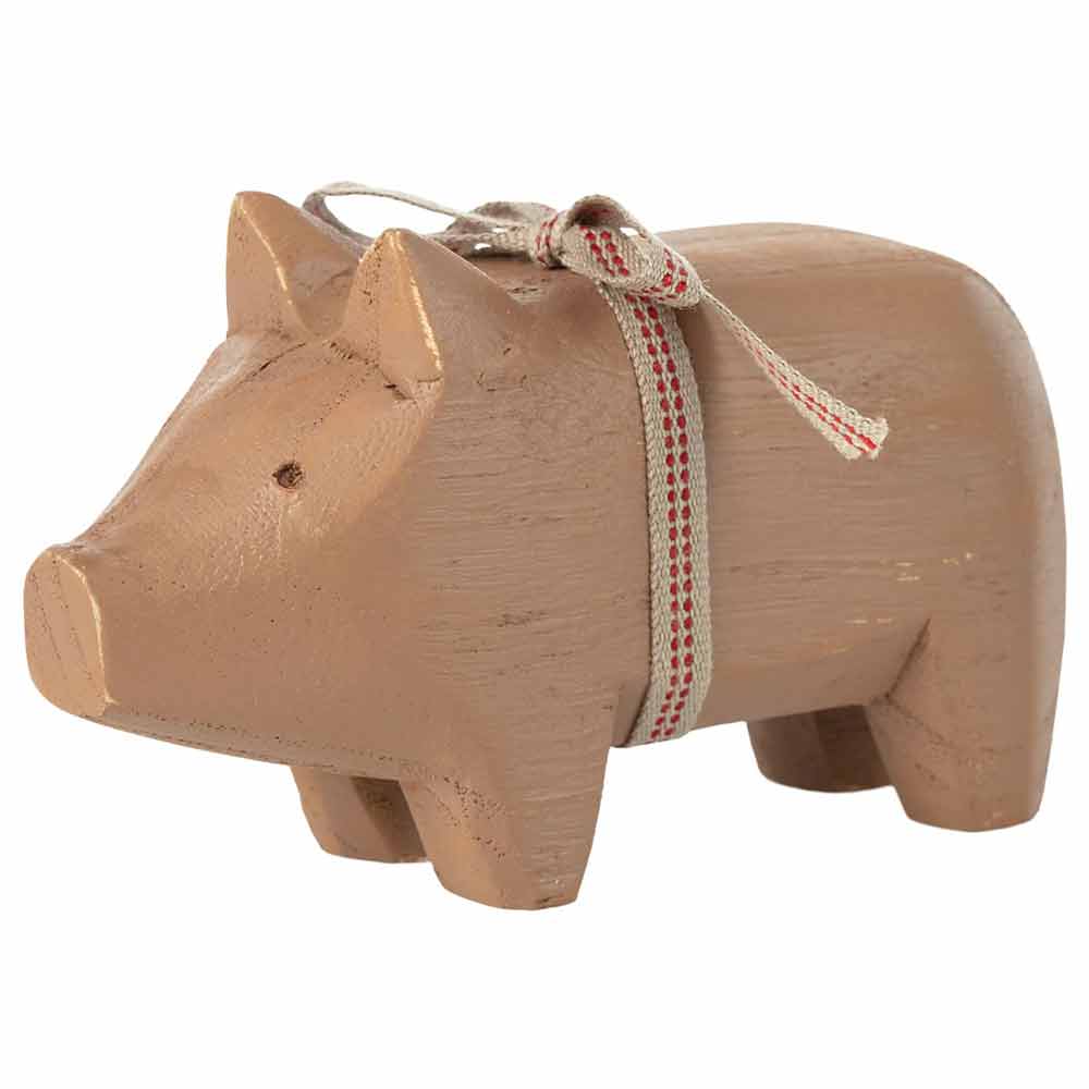 A wooden pig with a red and white ribbon, a symbol of luck and prosperity, handcrafted by Maileg. Perfect for holiday decoration or as a unique New Year's gift.
