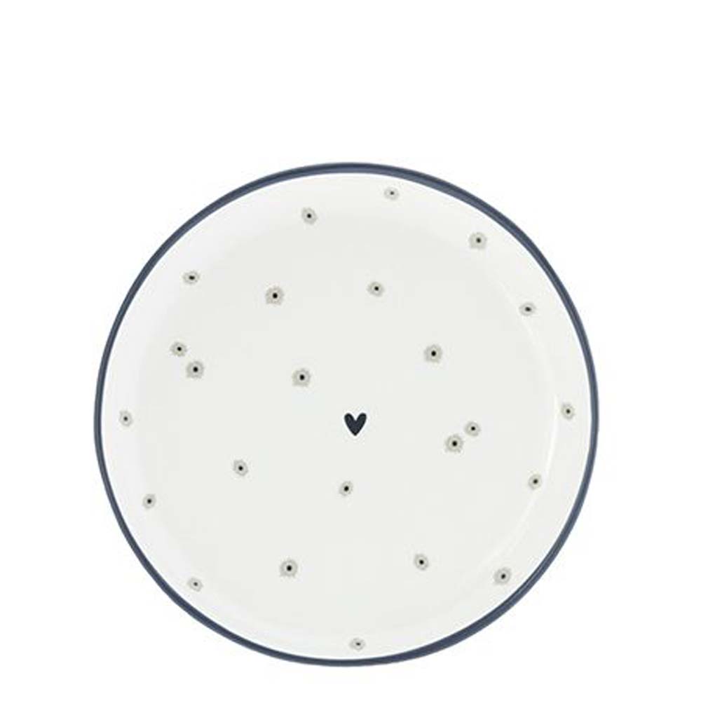 Ein weißer Bastion Collections – Teller Mini Daisies Teller mit schwarzen Punkten darauf.